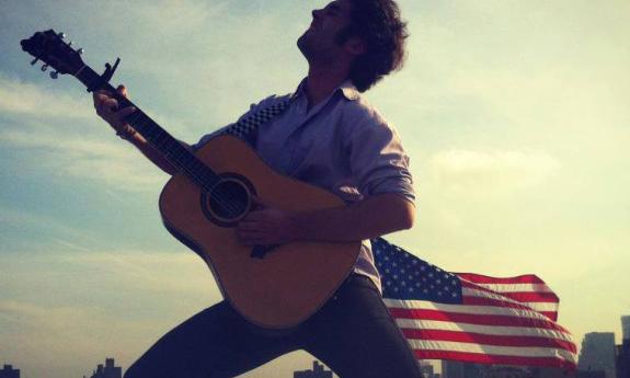 Jon Bailey folk musician with upside-down acoustic guitar